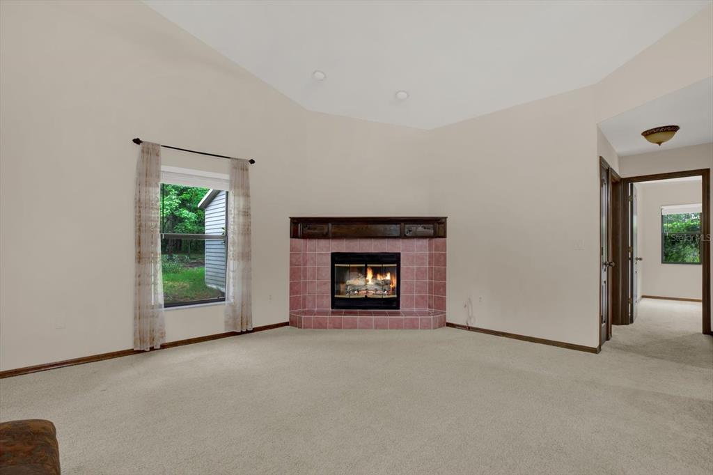 642 Erin Way Brooksville, FL 34601 - Photo 23 of 45 a view of an empty room with window and fire place