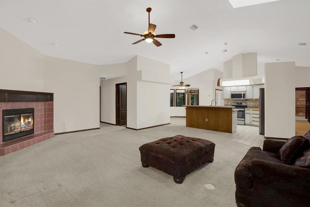 642 Erin Way Brooksville, FL 34601 - Photo 24 of 45 a living room with furniture and a fireplace