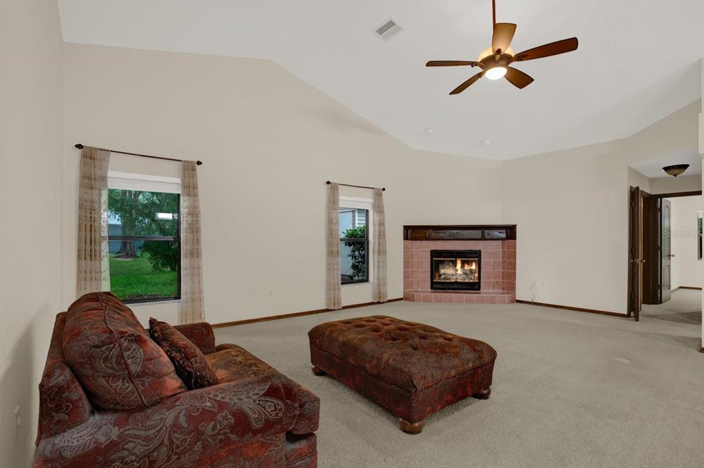 642 Erin Way Brooksville, FL 34601 - Photo 25 of 45 a living room with furniture and a fireplace