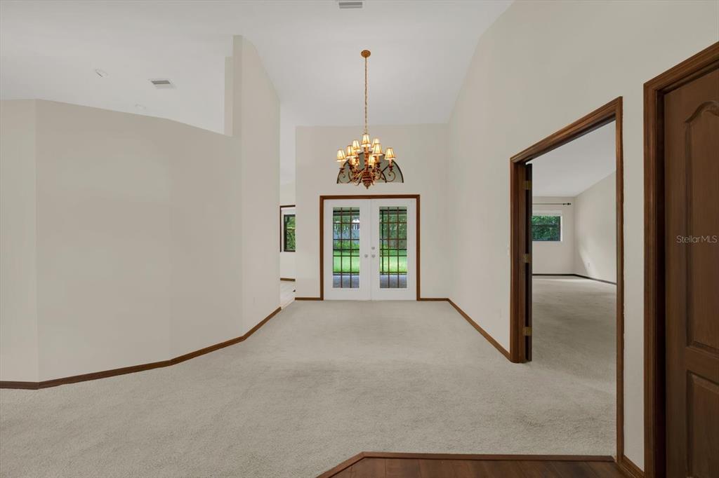 642 Erin Way Brooksville, FL 34601 - Photo 30 of 45 a view of a room with window wooden floor and chandelier