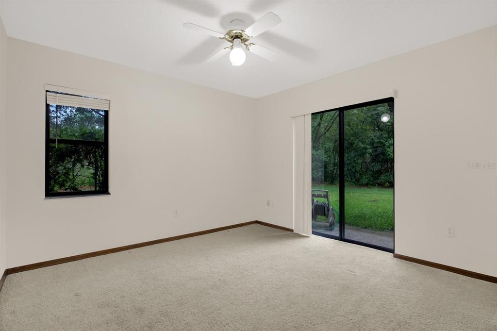 642 Erin Way Brooksville, FL 34601 - Photo 34 of 45 an empty room with windows and fan