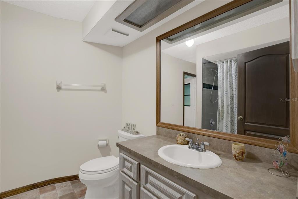 642 Erin Way Brooksville, FL 34601 - Photo 36 of 45 a bathroom with a granite countertop sink and a mirror