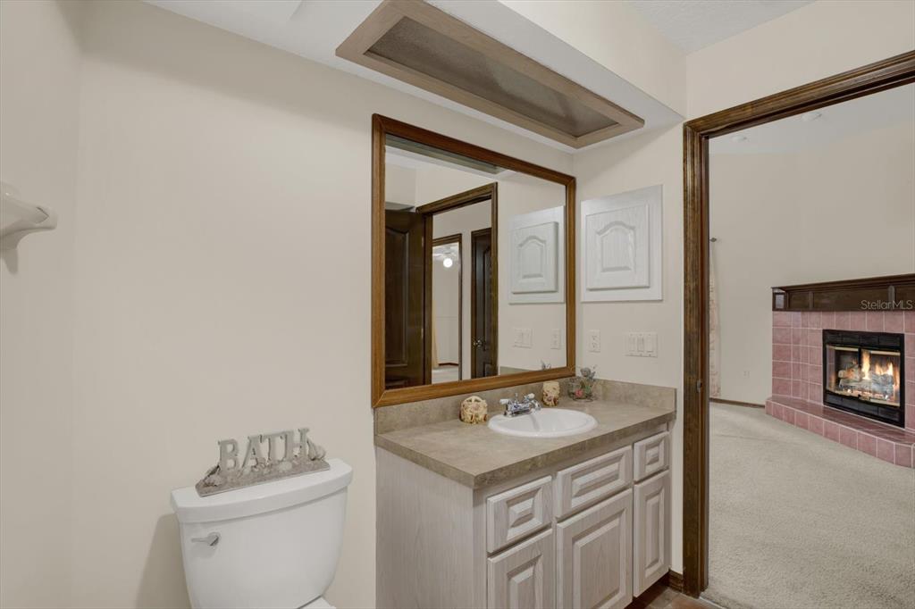 642 Erin Way Brooksville, FL 34601 - Photo 37 of 45 a bathroom with a sink toilet and mirror