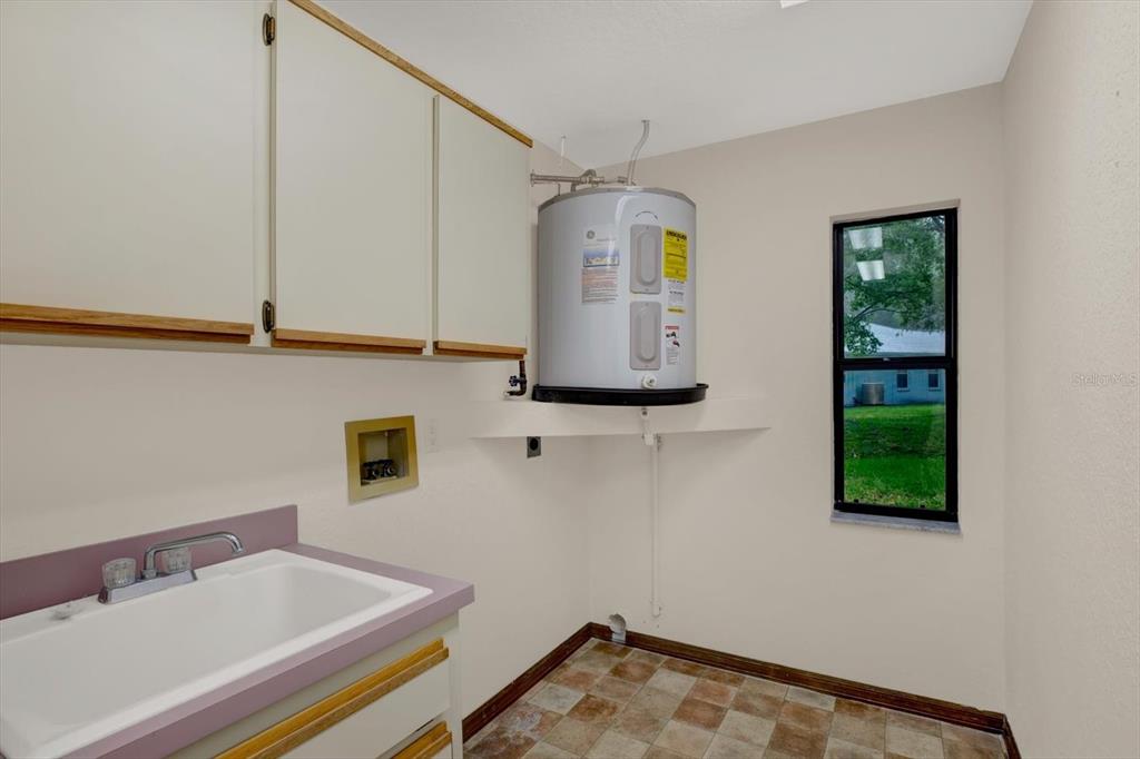 642 Erin Way Brooksville, FL 34601 - Photo 41 of 45 a bathroom with a sink and a mirror