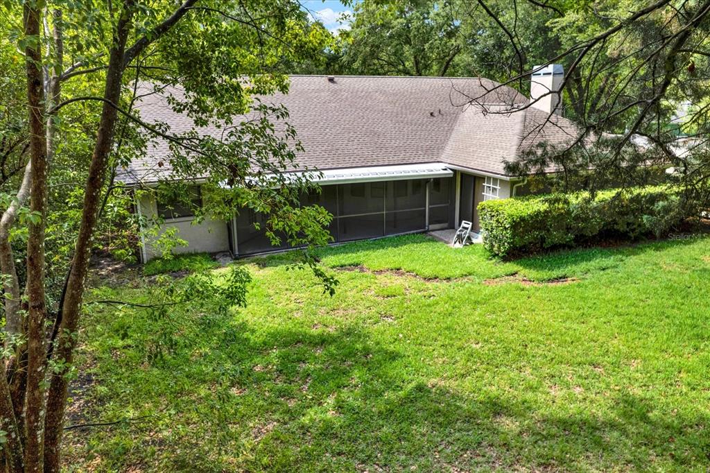 642 Erin Way Brooksville, FL 34601 - Photo 43 of 45 a view of house with garden and tall trees