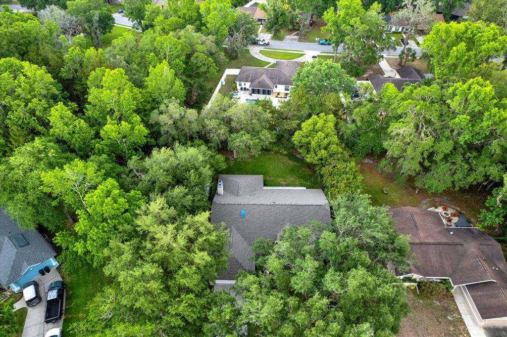 642 Erin Way Brooksville, FL 34601 - Photo 44 of 45 an aerial view of a house with a yard and lake view