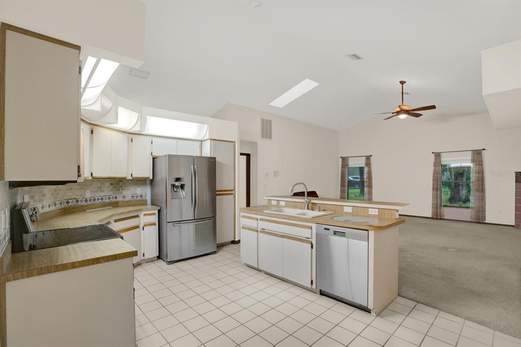 642 Erin Way Brooksville, FL 34601 - Photo 6 of 45 a kitchen with a sink and refrigerator