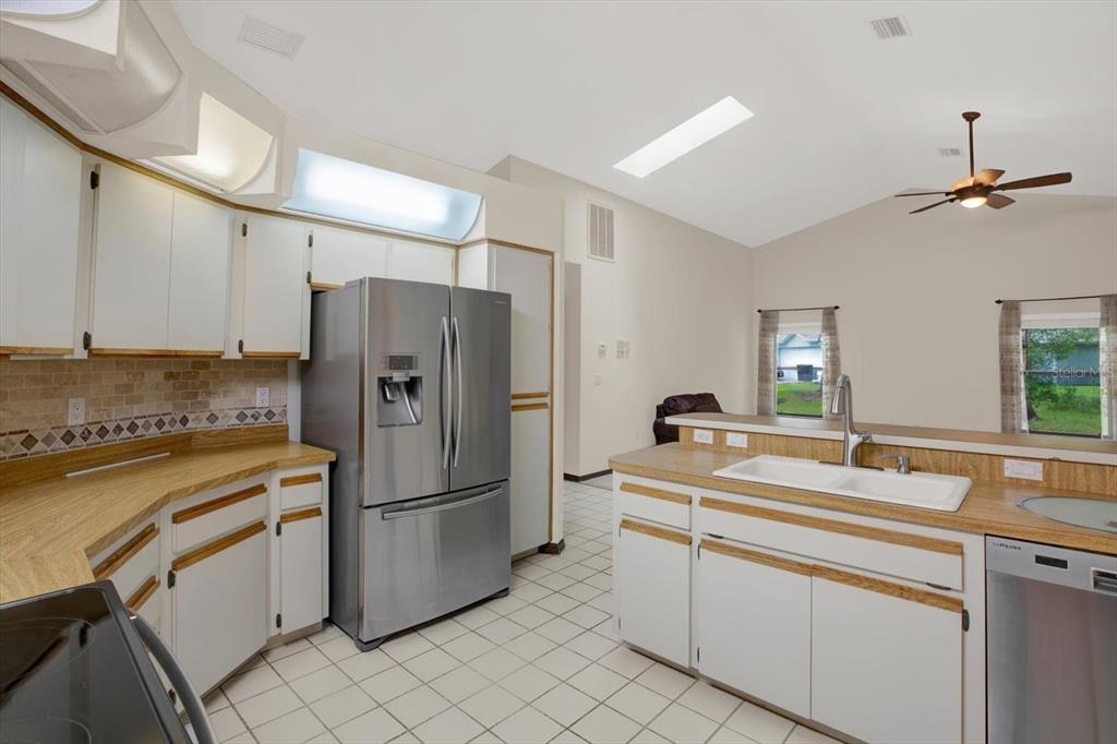 642 Erin Way Brooksville, FL 34601 - Photo 8 of 45 a kitchen with appliances a sink and cabinets