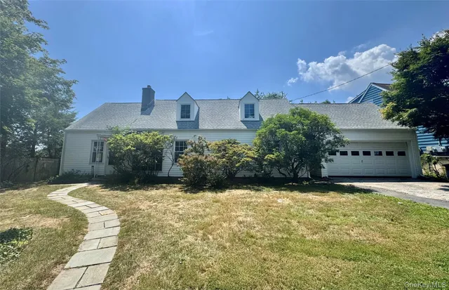 a view of a house with a yard and potted plants