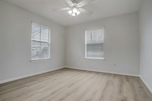 1304 Robin Street Houston, TX 77019 - Photo 7 of 11 Bedroom 2 with new luxury vinyl flooring, 2 large windows, blinds, ceiling fan & large closet.