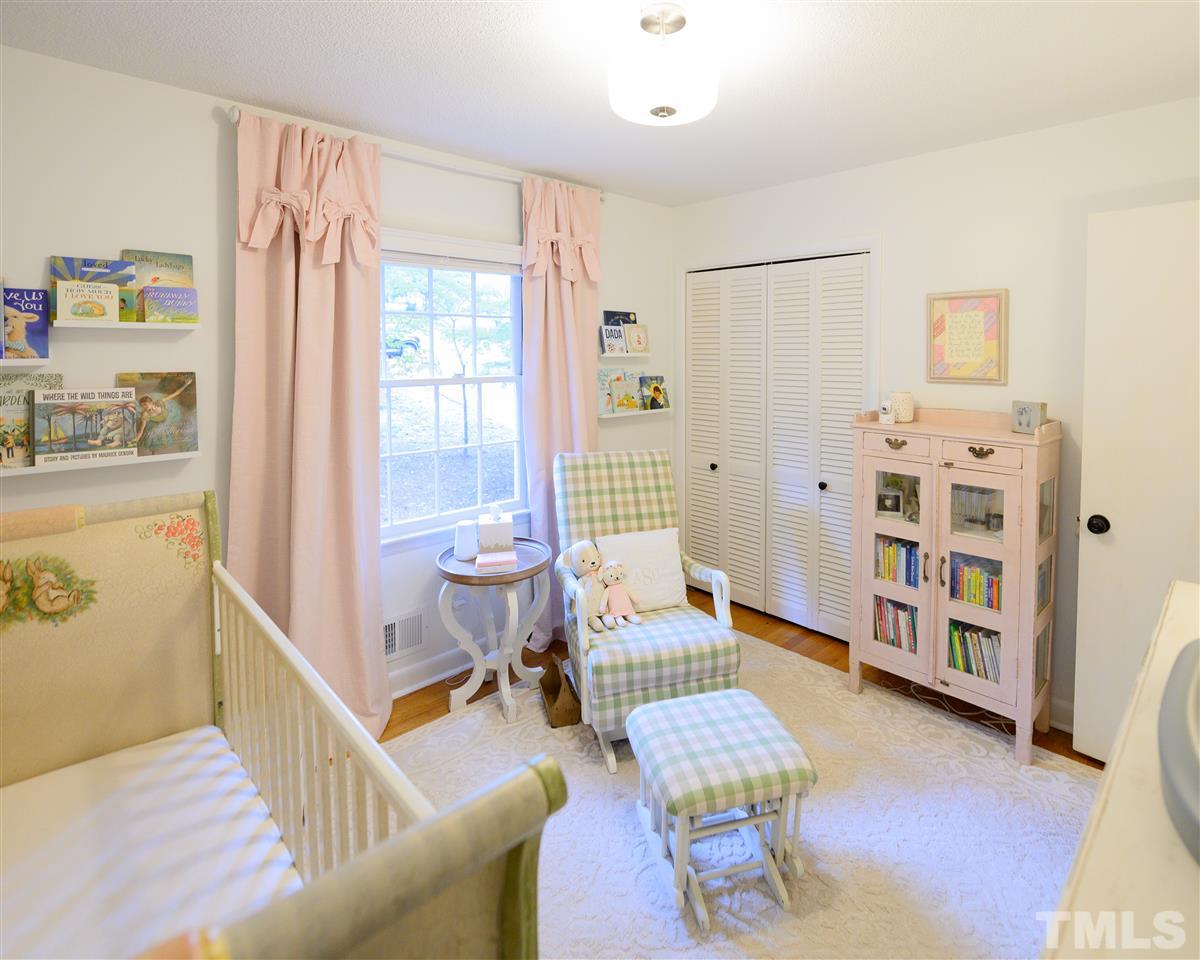 4917 Oak Park Road Raleigh, NC 27612 - Photo 12 of 25 a living room with furniture and a wooden floor