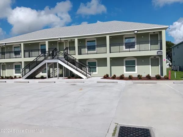 a front view of a house with a street