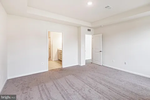 a view of an empty room and wooden floor
