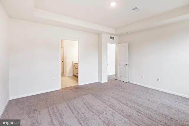 a view of an empty room and wooden floor