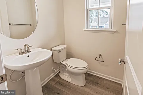 a white toilet sitting next to a bathroom sink
