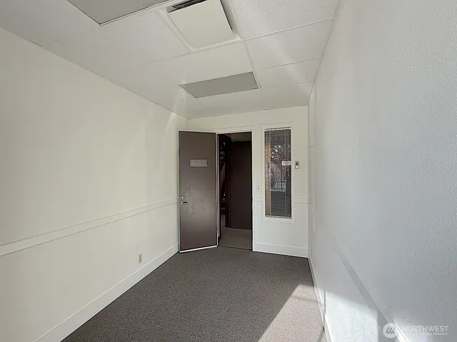 a view of a hallway with wooden shelves