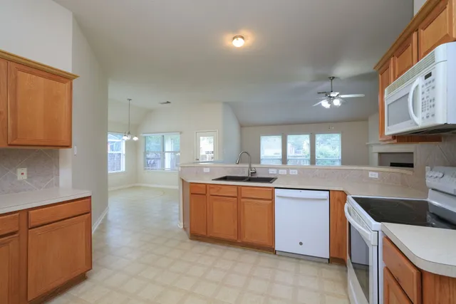a kitchen with stainless steel appliances granite countertop a sink and cabinets