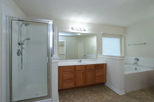 a bathroom with a double vanity sink and mirror with shower