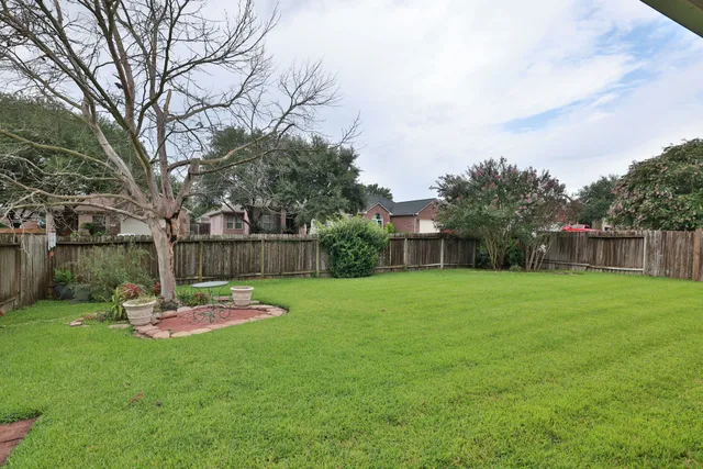 a front view of house with yard and trees