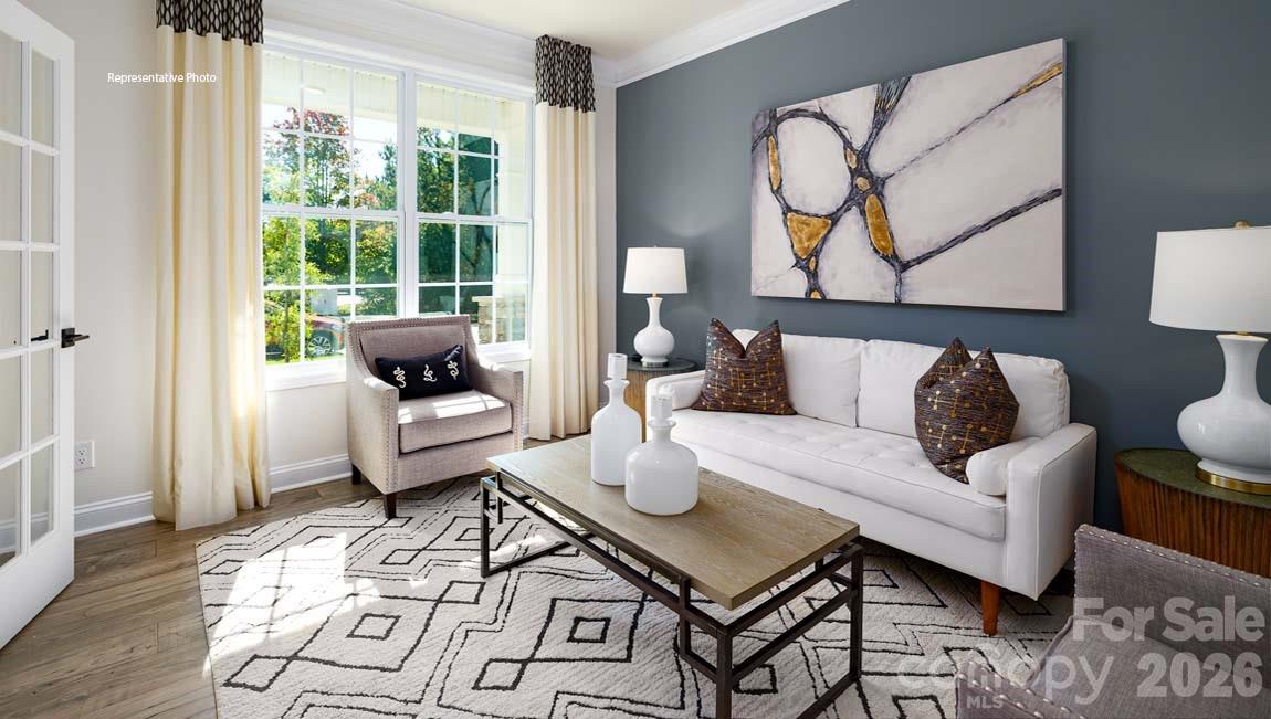 107 Rhuidean Court Troutman, NC 28166 - Photo 19 of 44 a living room with furniture and wooden floor