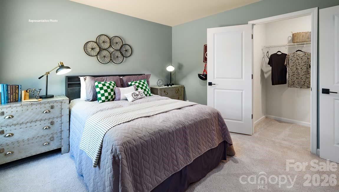 107 Rhuidean Court Troutman, NC 28166 - Photo 34 of 44 a bedroom with a bed and painting on the wall