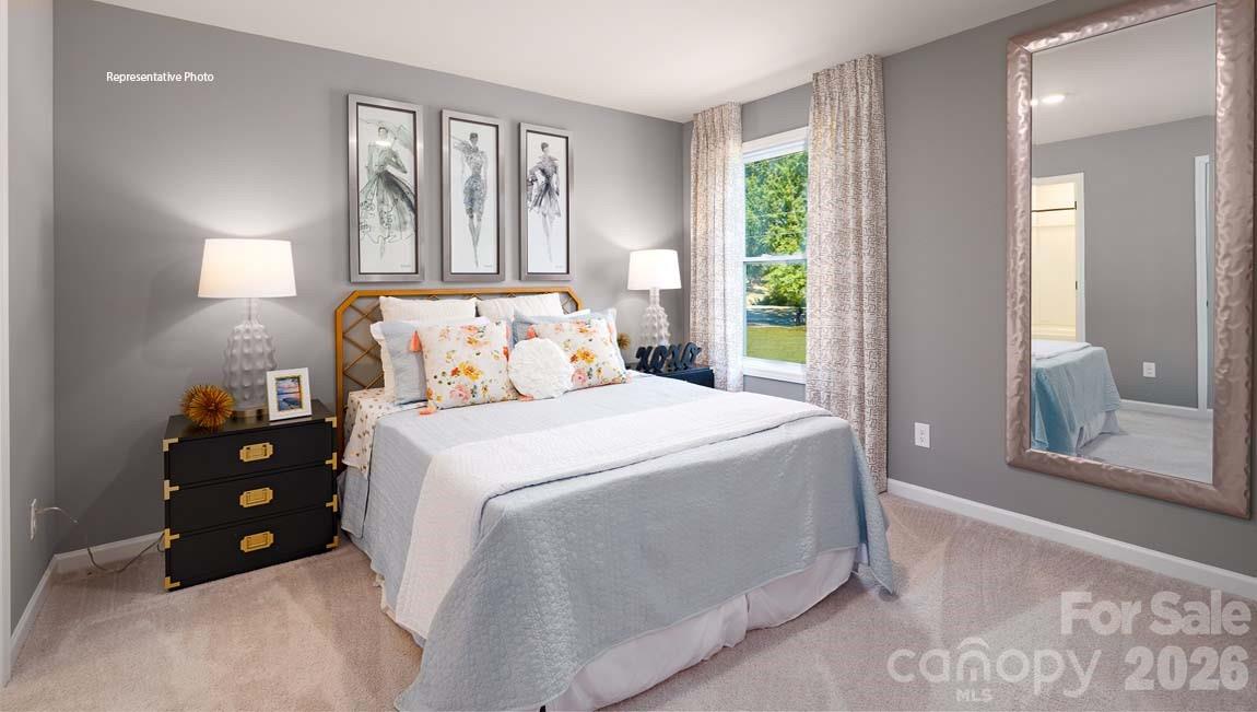 107 Rhuidean Court Troutman, NC 28166 - Photo 35 of 44 a bedroom with a bed and a large window