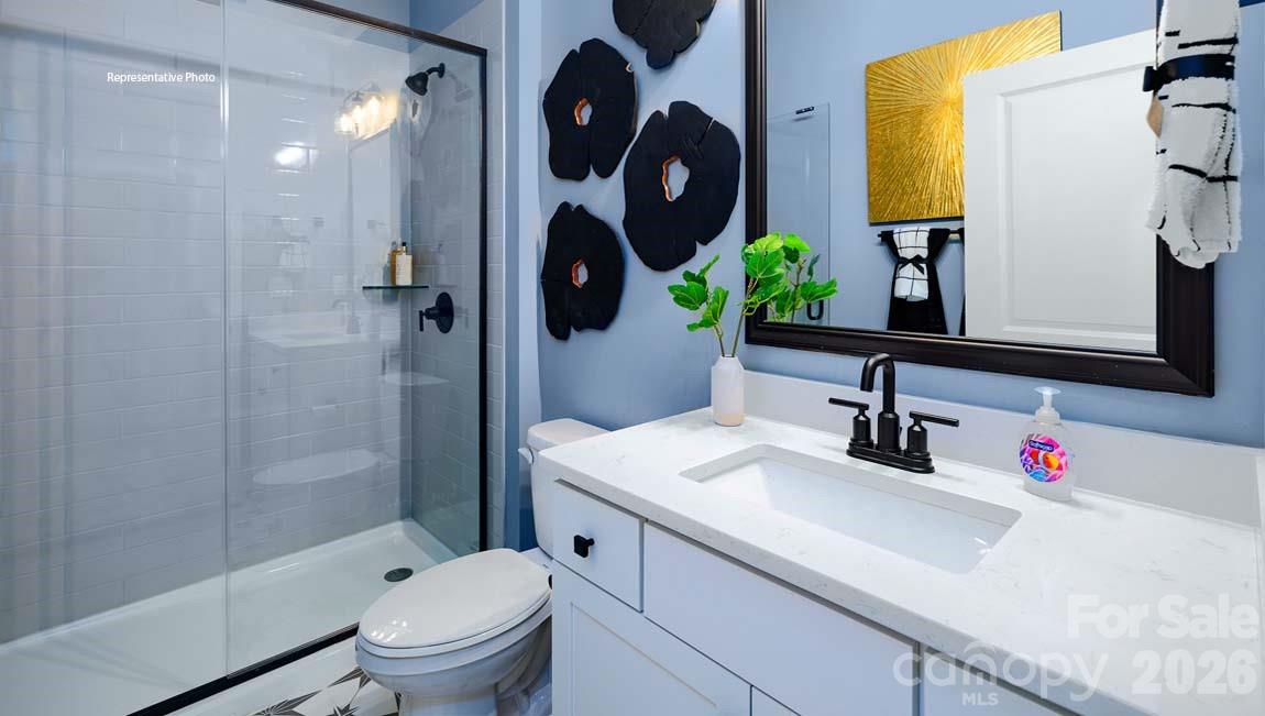 107 Rhuidean Court Troutman, NC 28166 - Photo 39 of 44 a bathroom with a sink vanity mirror and toilet
