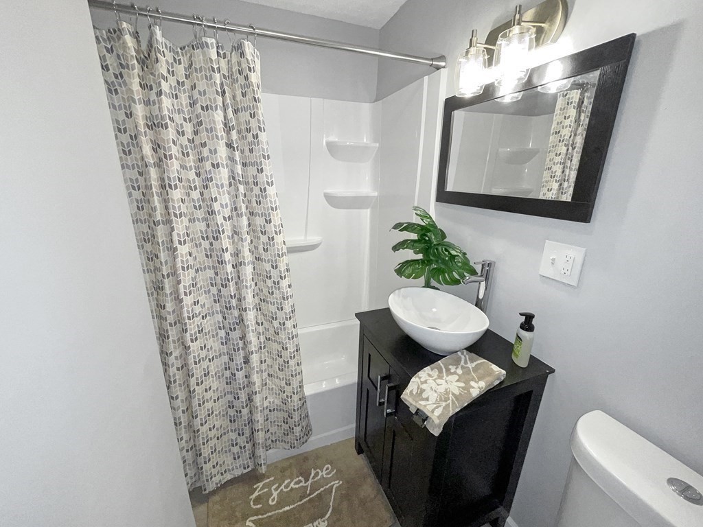 12 Ladd Street Springfield, MA 01109 - Photo 30 of 37 a living room with furniture and a toilet