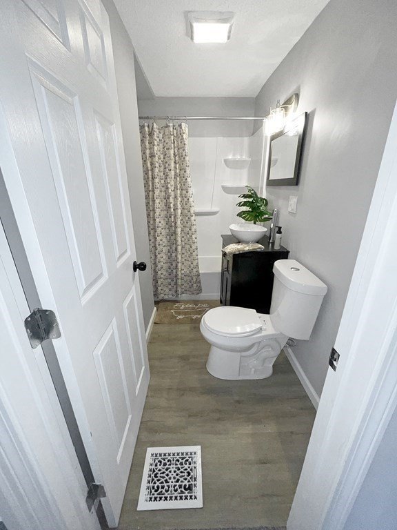 12 Ladd Street Springfield, MA 01109 - Photo 32 of 37 a bathroom with a toilet a sink and a mirror