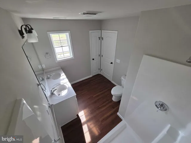 a view of entryway with window and wooden floor