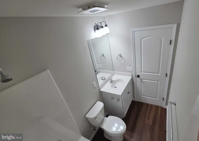 a white toilet sitting next to a bathroom sink