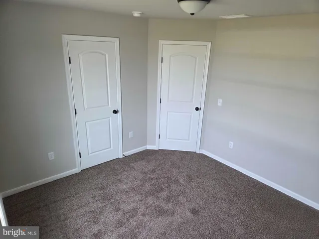 a view of an empty room and entryway