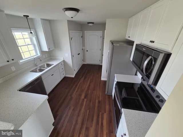 a kitchen with wooden floors and a stove