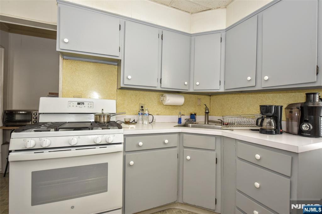 142 South Main Street Hackensack, NJ 07601 - Photo 18 of 33 a kitchen with cabinets appliances a sink and a stove