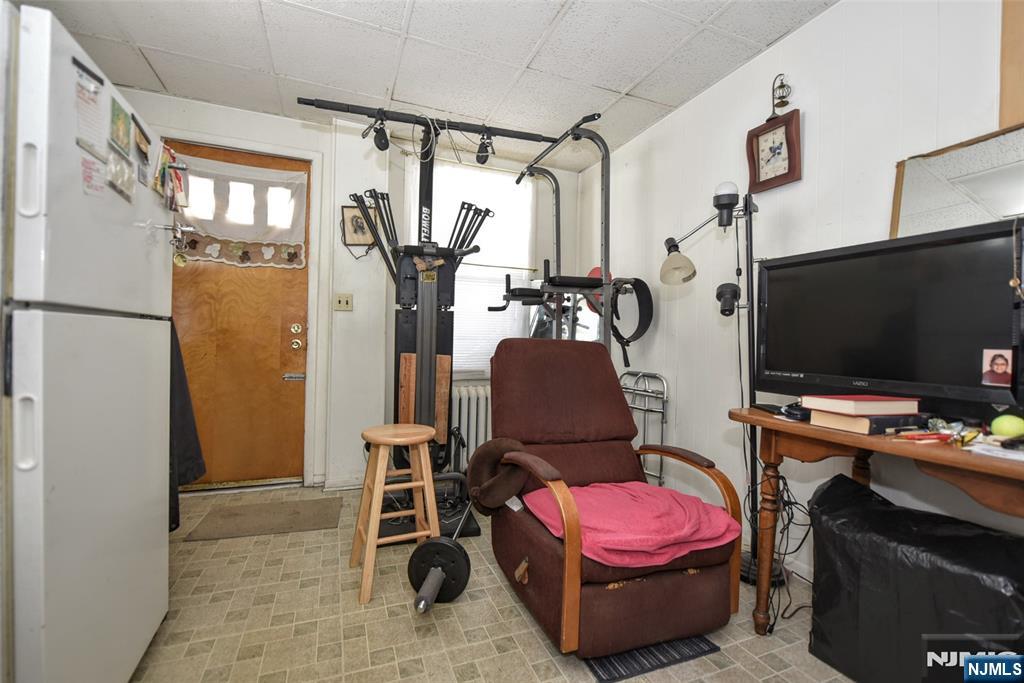 142 South Main Street Hackensack, NJ 07601 - Photo 19 of 33 a room with gym equipment and a flat screen tv