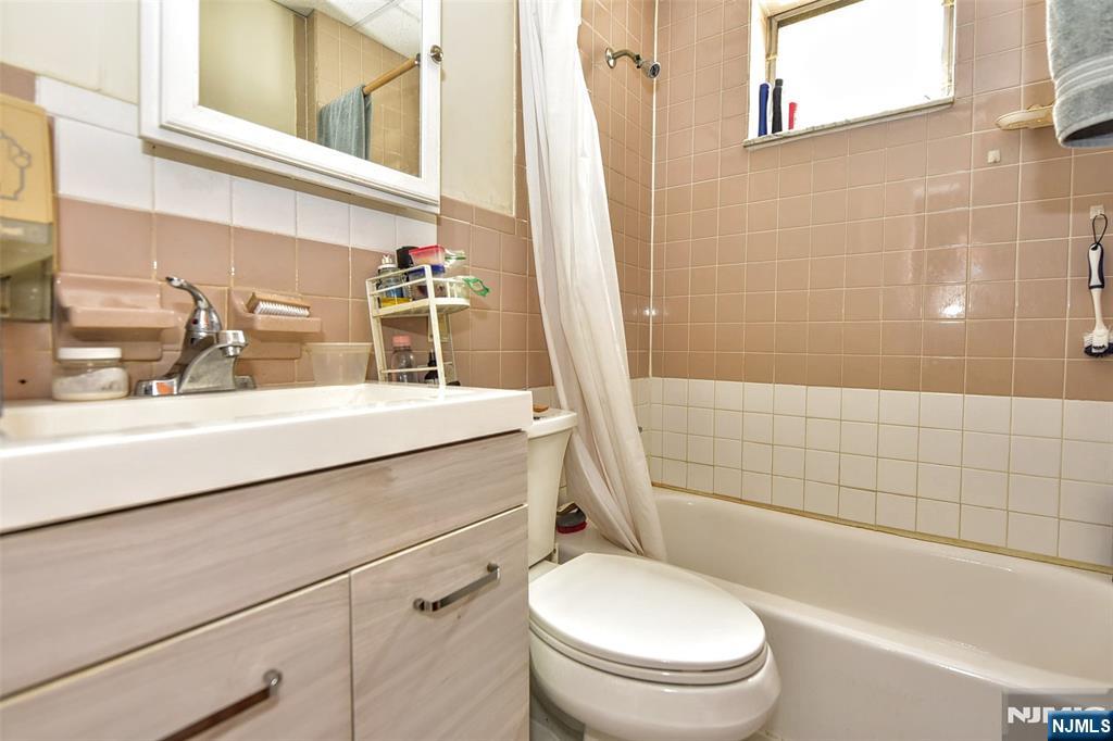 142 South Main Street Hackensack, NJ 07601 - Photo 21 of 33 a bathroom with a sink a toilet a mirror and shower