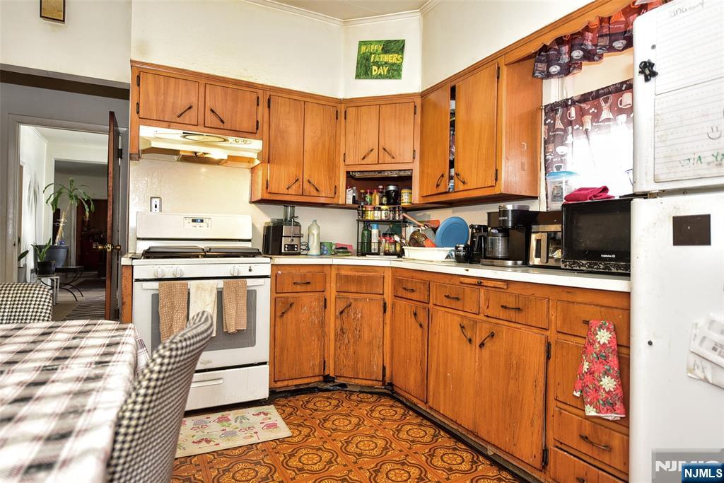 142 South Main Street Hackensack, NJ 07601 - Photo 8 of 33 a kitchen with stainless steel appliances granite countertop a refrigerator a sink and white cabinets
