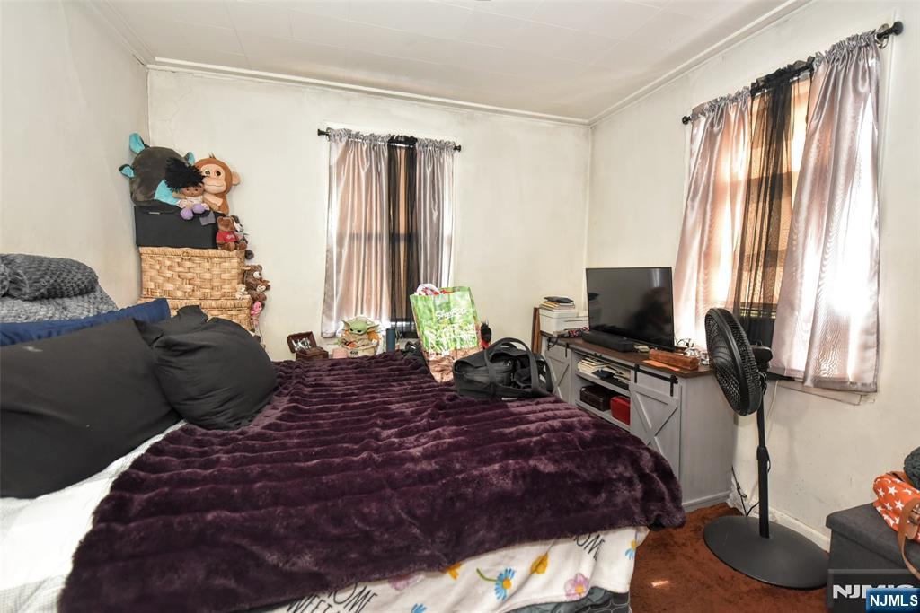 142 South Main Street Hackensack, NJ 07601 - Photo 10 of 33 a bed room with a bed and a television