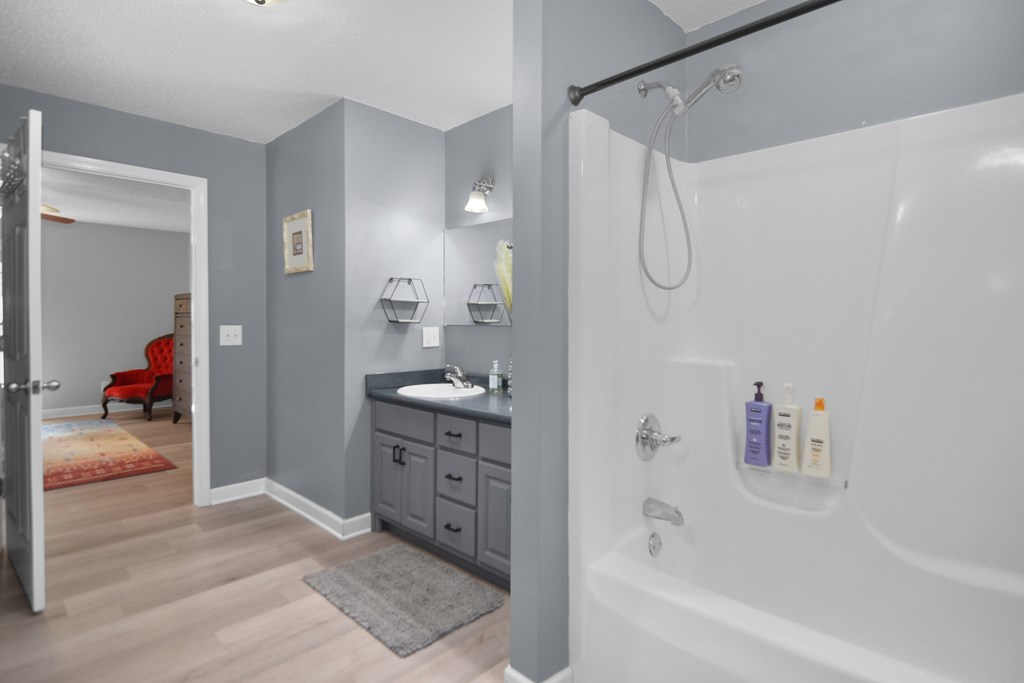 78 Bluebird Lane Blue Ridge, GA 30513 - Photo 15 of 29 a bathroom with a granite countertop sink a mirror and a shower