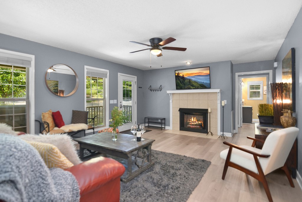 78 Bluebird Lane Blue Ridge, GA 30513 - Photo 8 of 29 a living room with furniture a fireplace and a large window