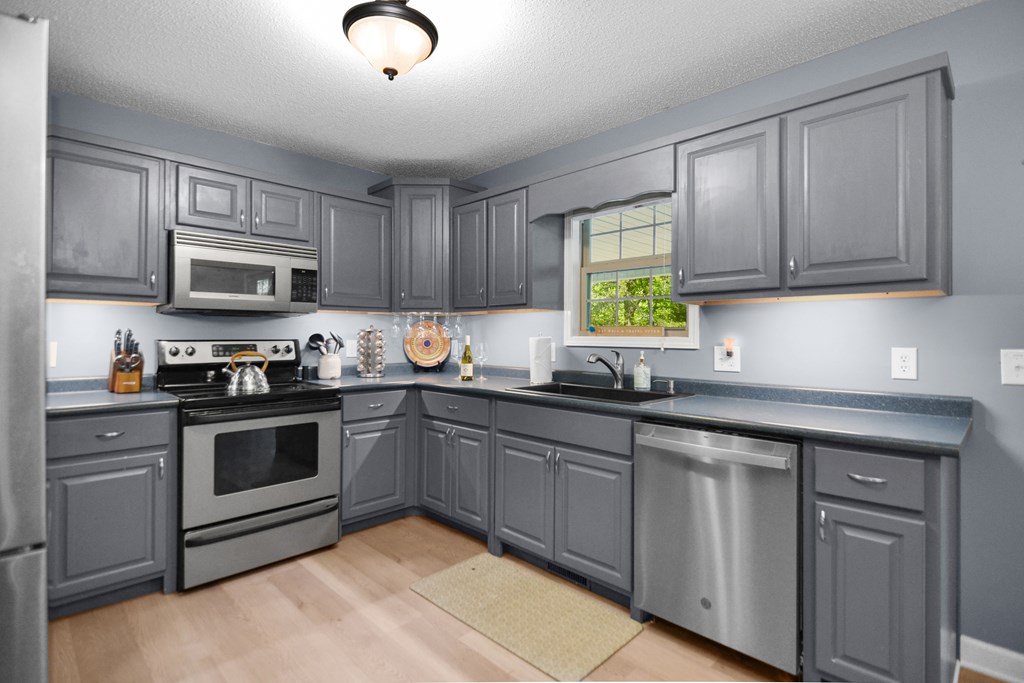78 Bluebird Lane Blue Ridge, GA 30513 - Photo 10 of 29 a kitchen with granite countertop cabinets stainless steel appliances and a window