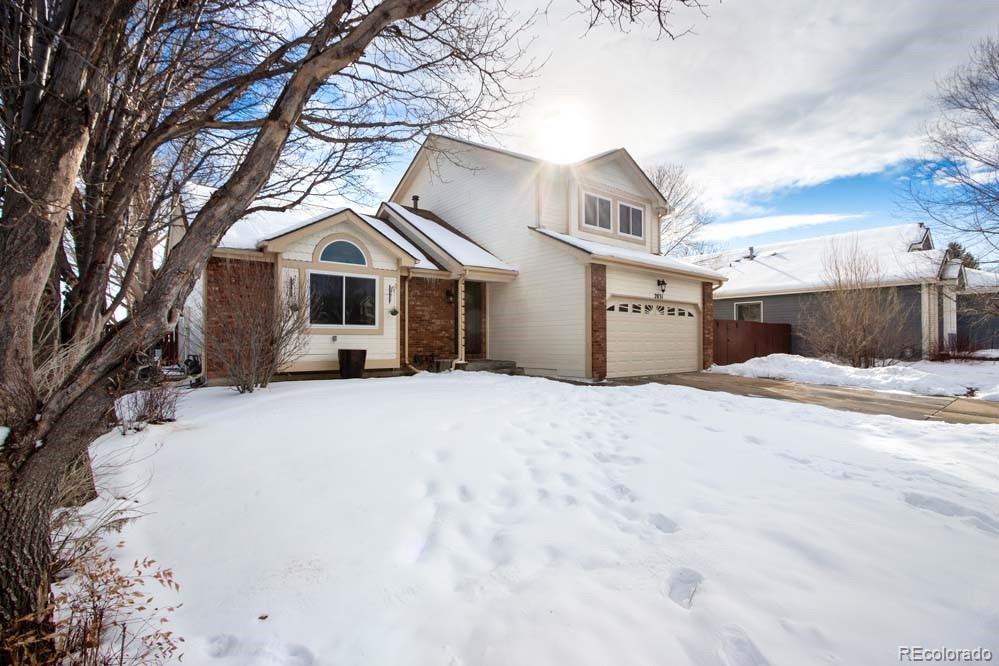 2031 Prairie View Court Fort Collins, CO 80526 - Photo 1 of 33 a front view of a house with a yard covered in snow