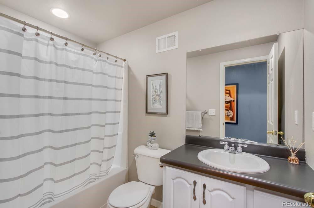 2031 Prairie View Court Fort Collins, CO 80526 - Photo 15 of 33 a bathroom with a granite countertop toilet sink and mirror