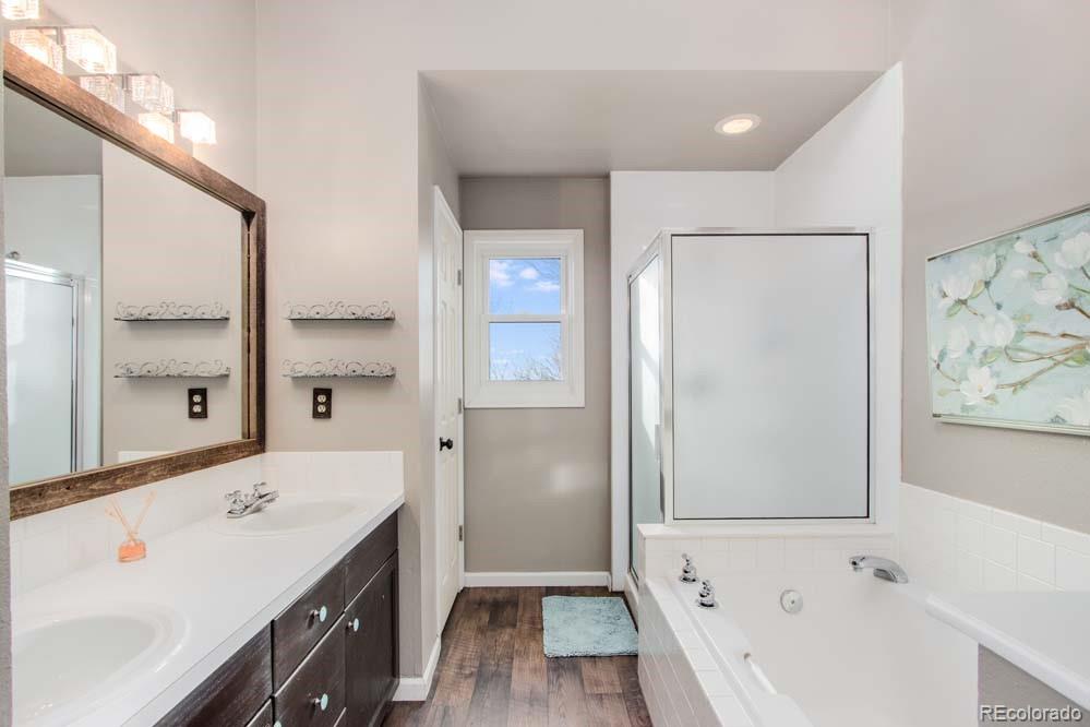 2031 Prairie View Court Fort Collins, CO 80526 - Photo 17 of 33 a view of a bathroom with a tub sink and mirror
