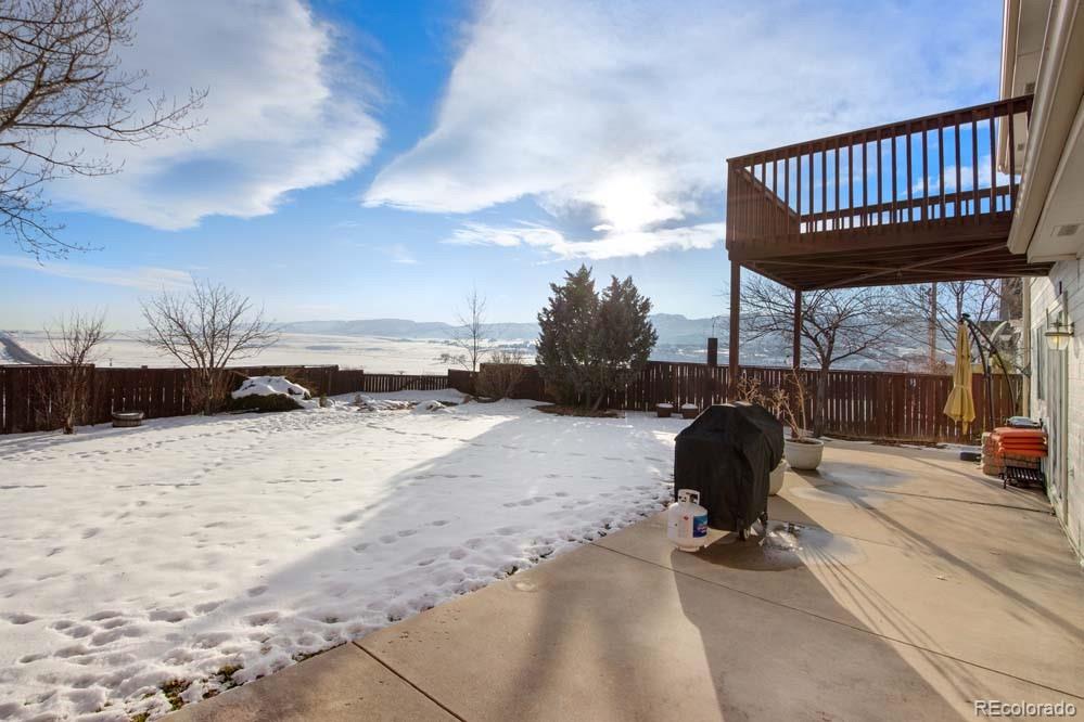 2031 Prairie View Court Fort Collins, CO 80526 - Photo 23 of 33 a view of roof deck with table and chairs a barbeque with wooden floor and fence