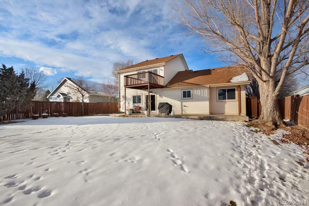 2031 Prairie View Court Fort Collins, CO 80526 - Photo 24 of 33 a front view of a house with a dirt yard and a large tree