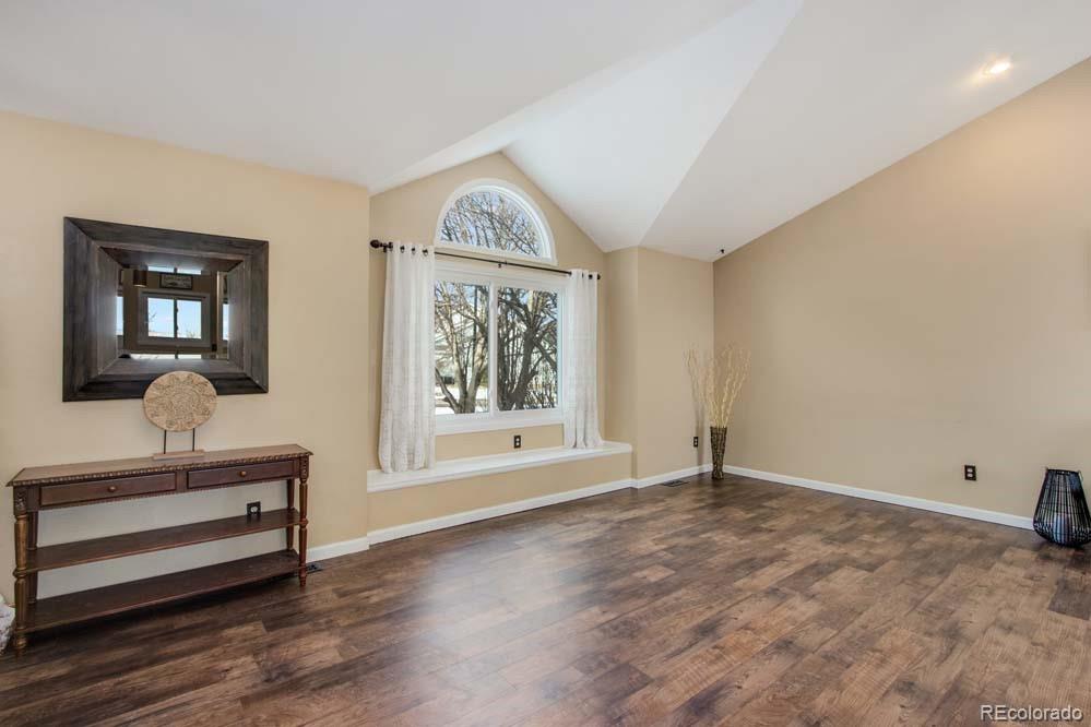 2031 Prairie View Court Fort Collins, CO 80526 - Photo 4 of 33 a view of an empty room with a window and wooden floor