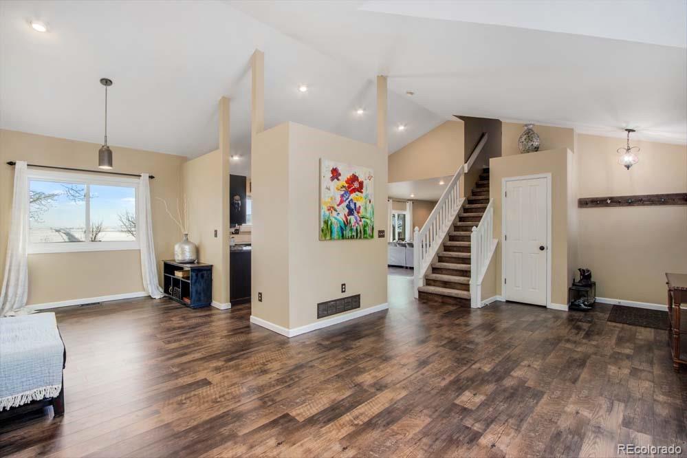 2031 Prairie View Court Fort Collins, CO 80526 - Photo 5 of 33 a view of a living room with wooden floor and stairs