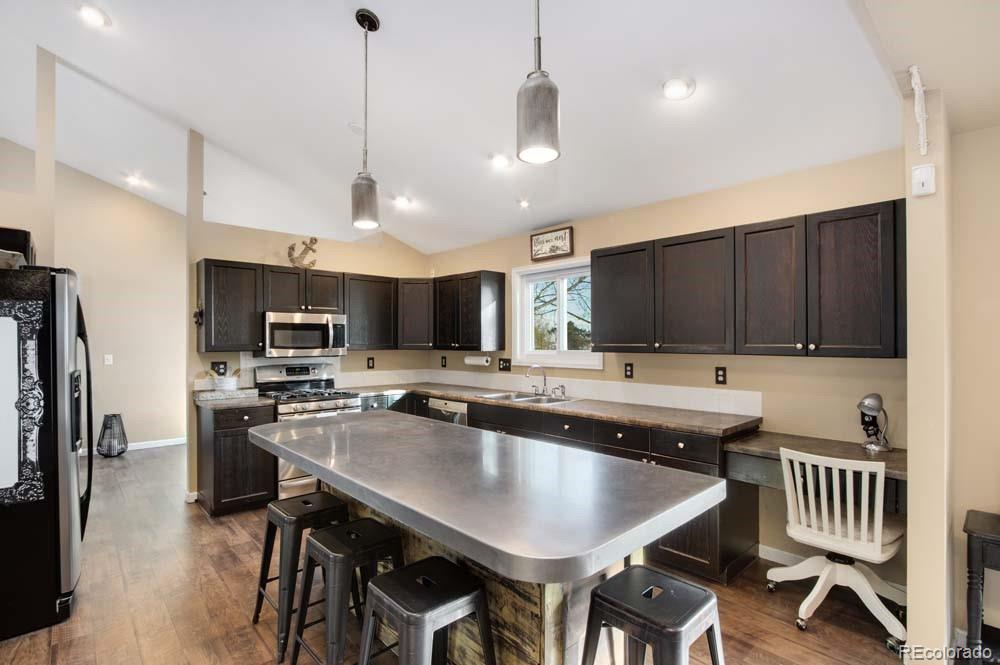 2031 Prairie View Court Fort Collins, CO 80526 - Photo 8 of 33 a kitchen with kitchen island a dining table and chairs
