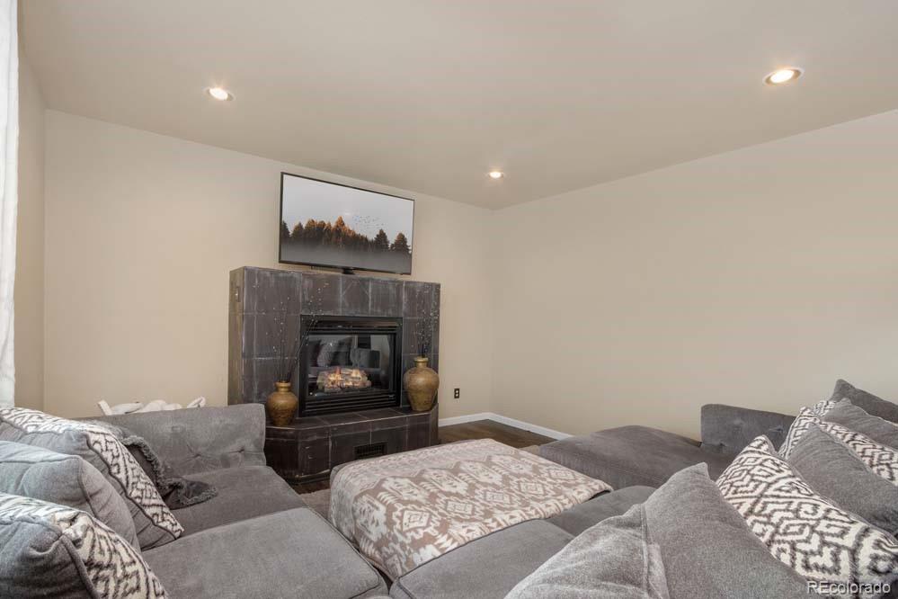 2031 Prairie View Court Fort Collins, CO 80526 - Photo 10 of 33 a living room with furniture and a fireplace